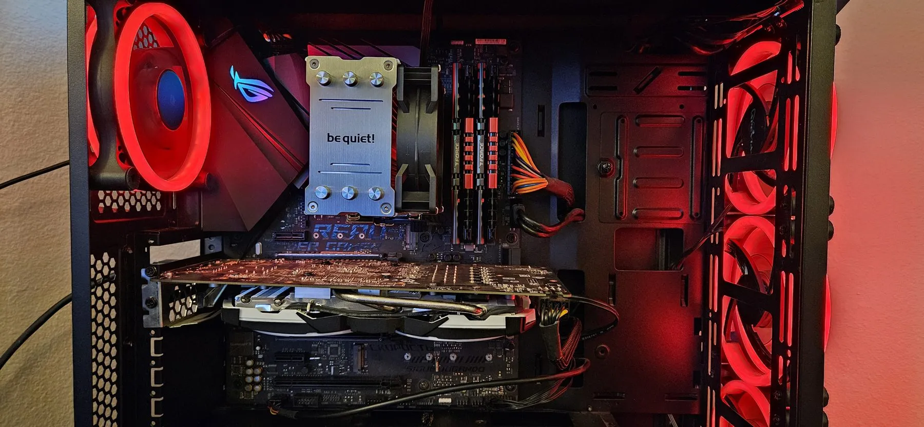 The rebuilt PC lit red, with the new cooler and motherboard