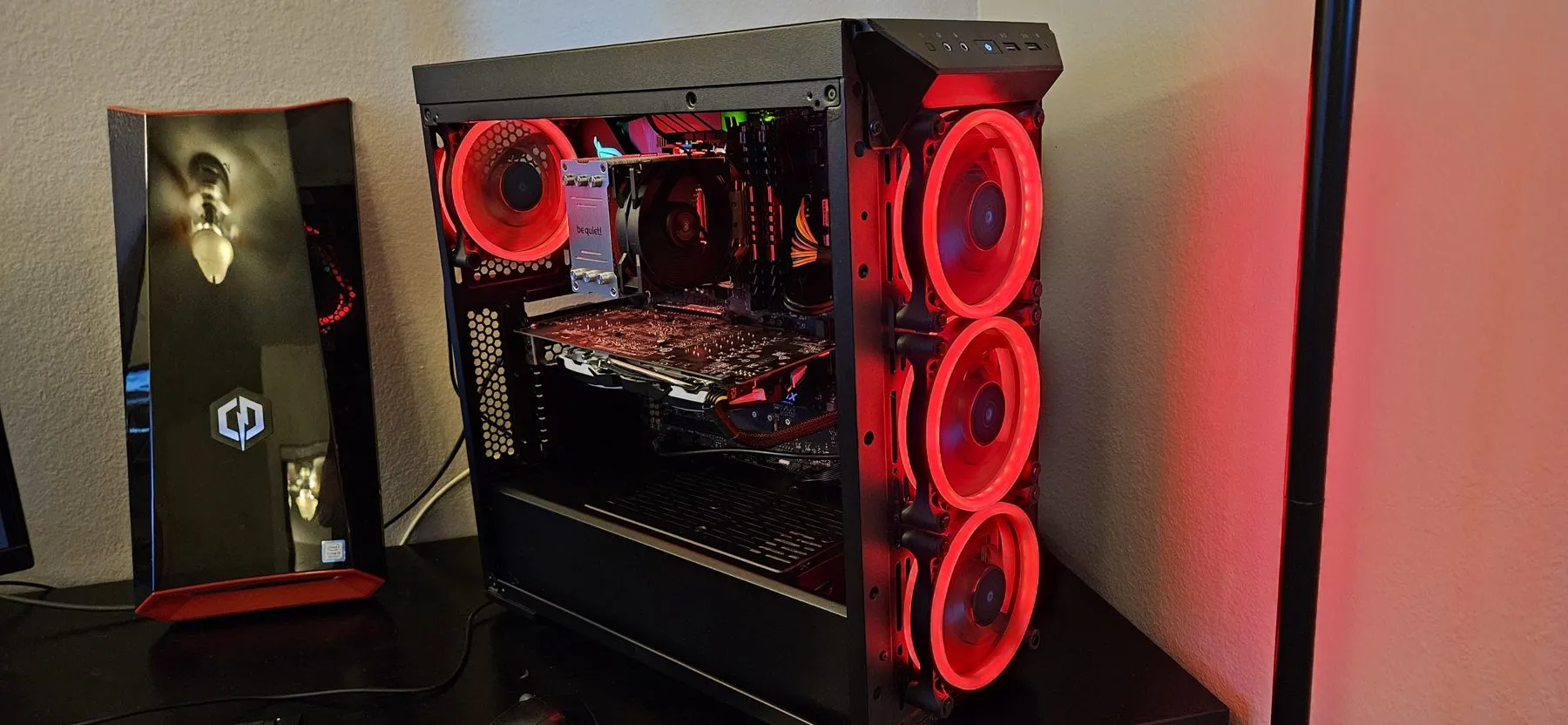 The rebuilt PC with its side panel on, glowing red
