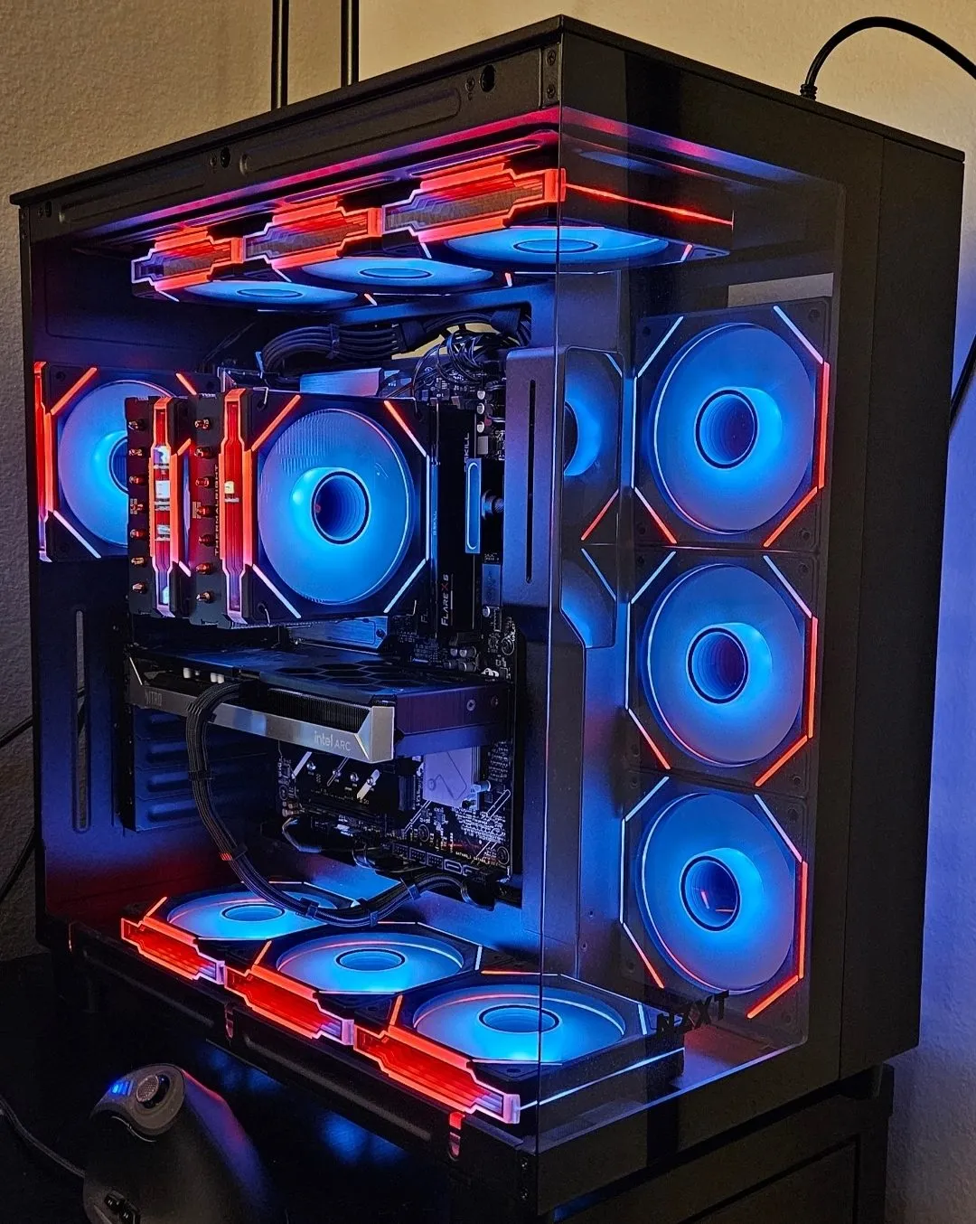 The AM5 build with the Arc B580, blue side fans and red top fans